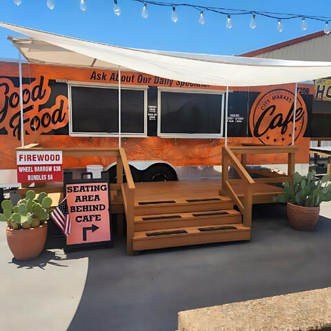 Orange Levi's Lunchbox food truck with wood counter and cafe signage parked at City Marketplace